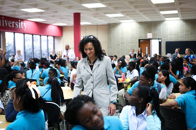 CGLA Executive Director Elaine Swafford walks through tables of her students on the first day of the 2015 school year. The school recently graduated its inaugural sixth-grade class which entered the school as it opened in 2009.