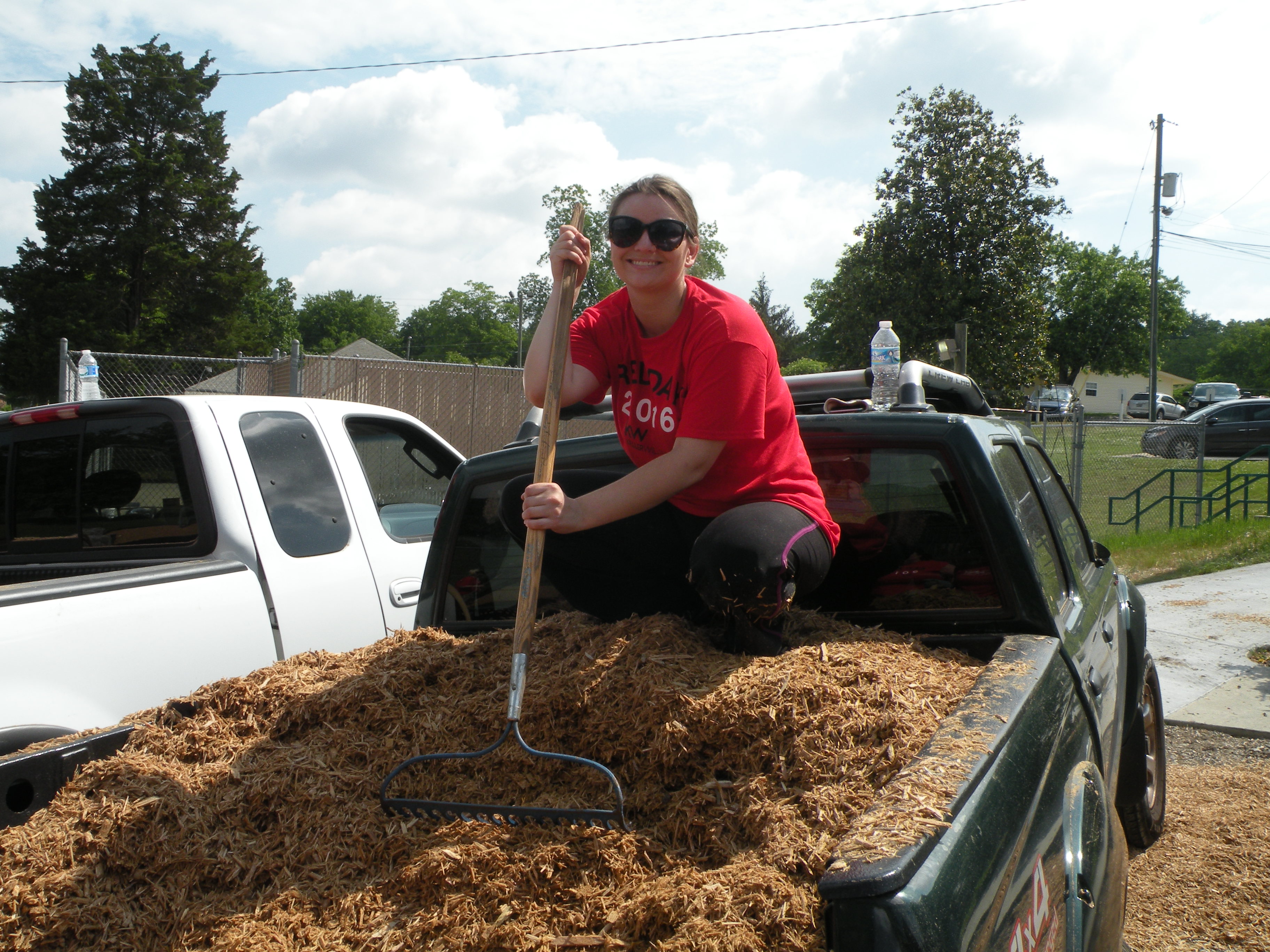 Amanda Durham gets ready to dig into a truckbed full of mulch.