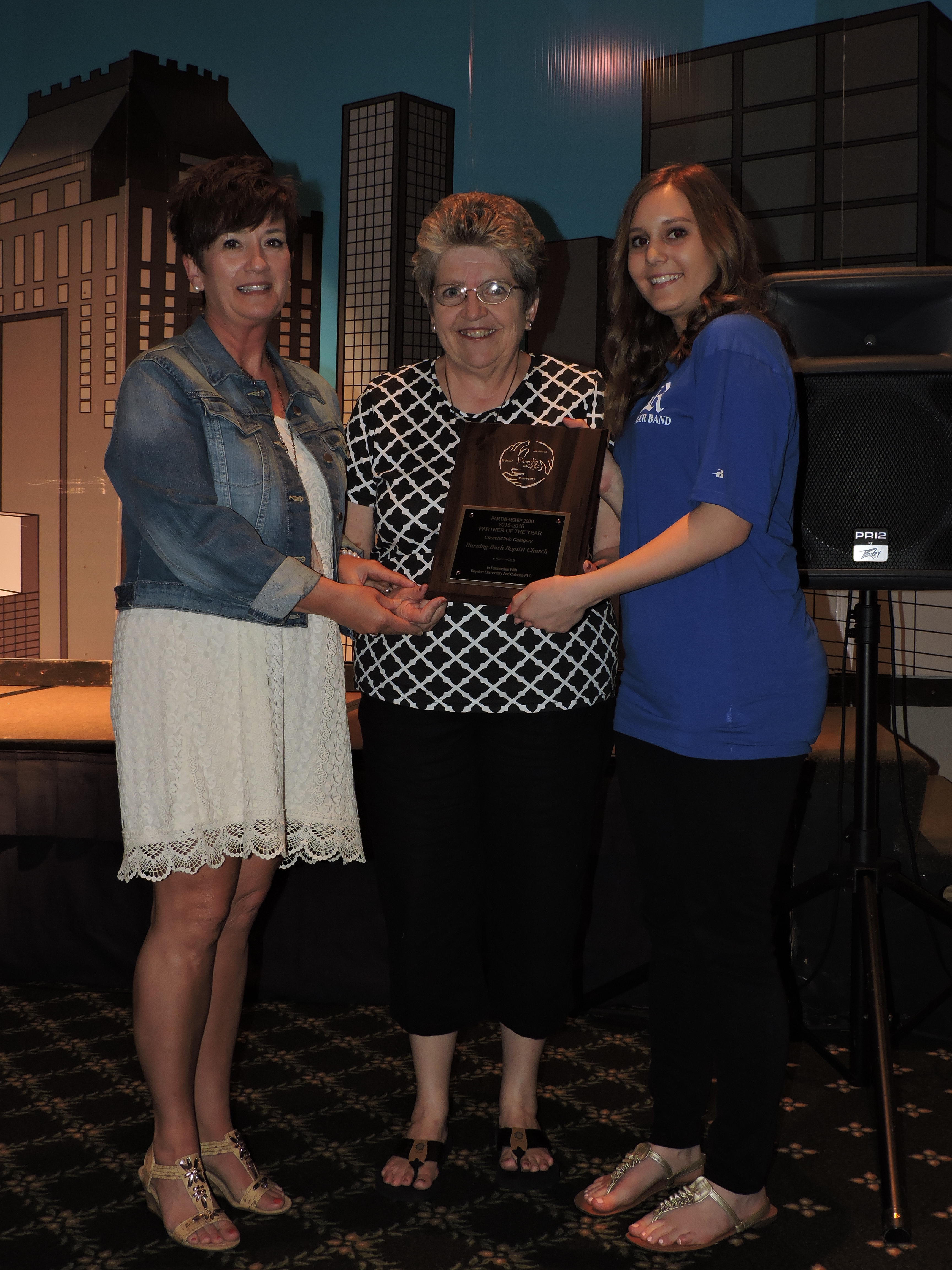 The Partnership 2000's Civic/Religious Partner of the Year designation is awarded to Mitzi Callahan and Kay Shipley by Ringgold High School student Inna Kouzniaeva, from left. The WOW Women's Ministry group adopted the Parents as Teachers Program at the Performance Learning Center and provided goody bags, sponsored a book drive, made bookmarks, birthday bags and donated supplies to help make home visits special.
