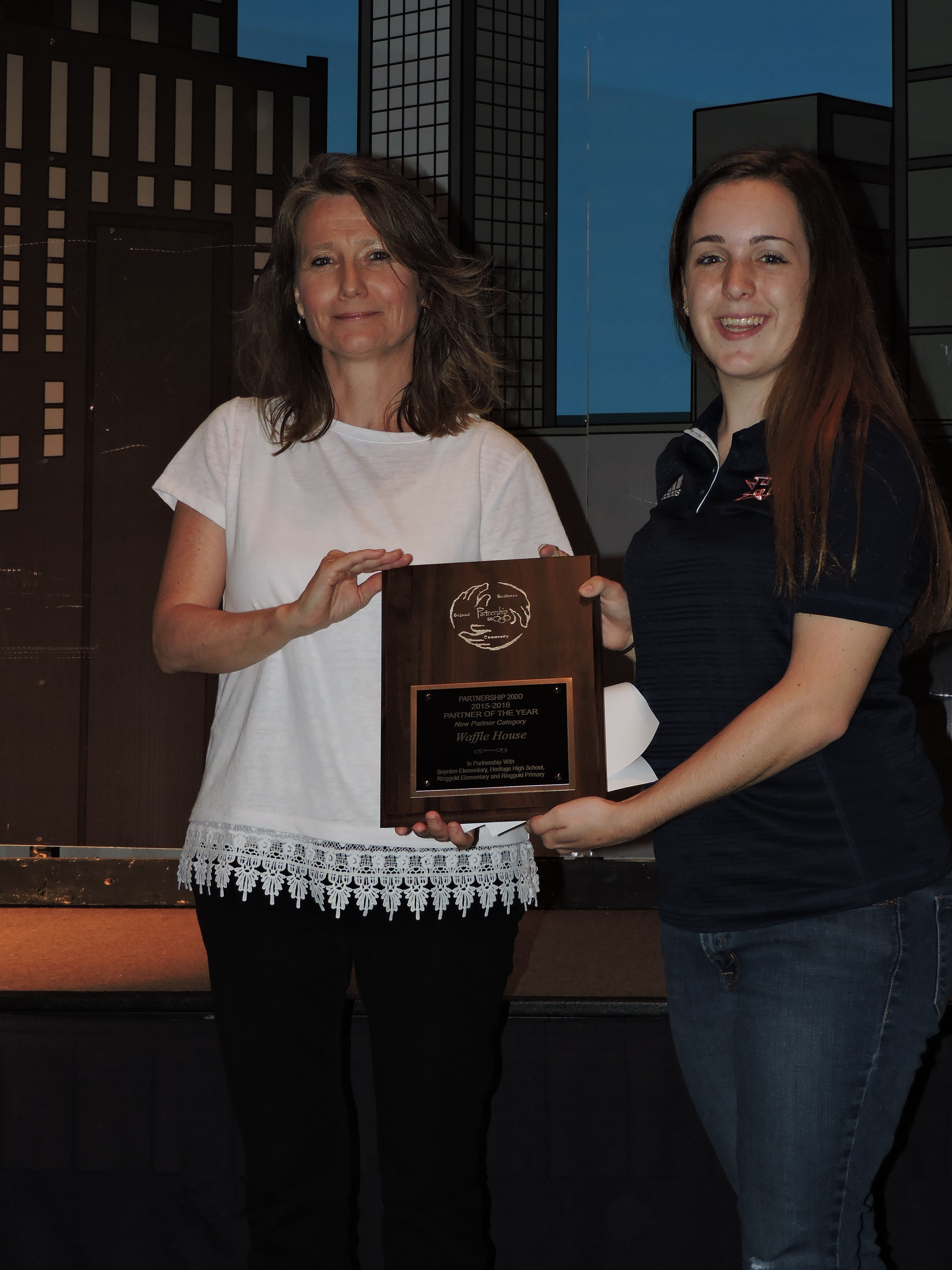 Waffle House is named the New Partner of the Year. Heritage High School student Katie Beth Carter, right, presents the award. Waffle House sponsored a Senior Breakfast at Heritage High, donated coupon books to local elementary schools, donated school supplies, coffee and gift certificates for teacher incentives.