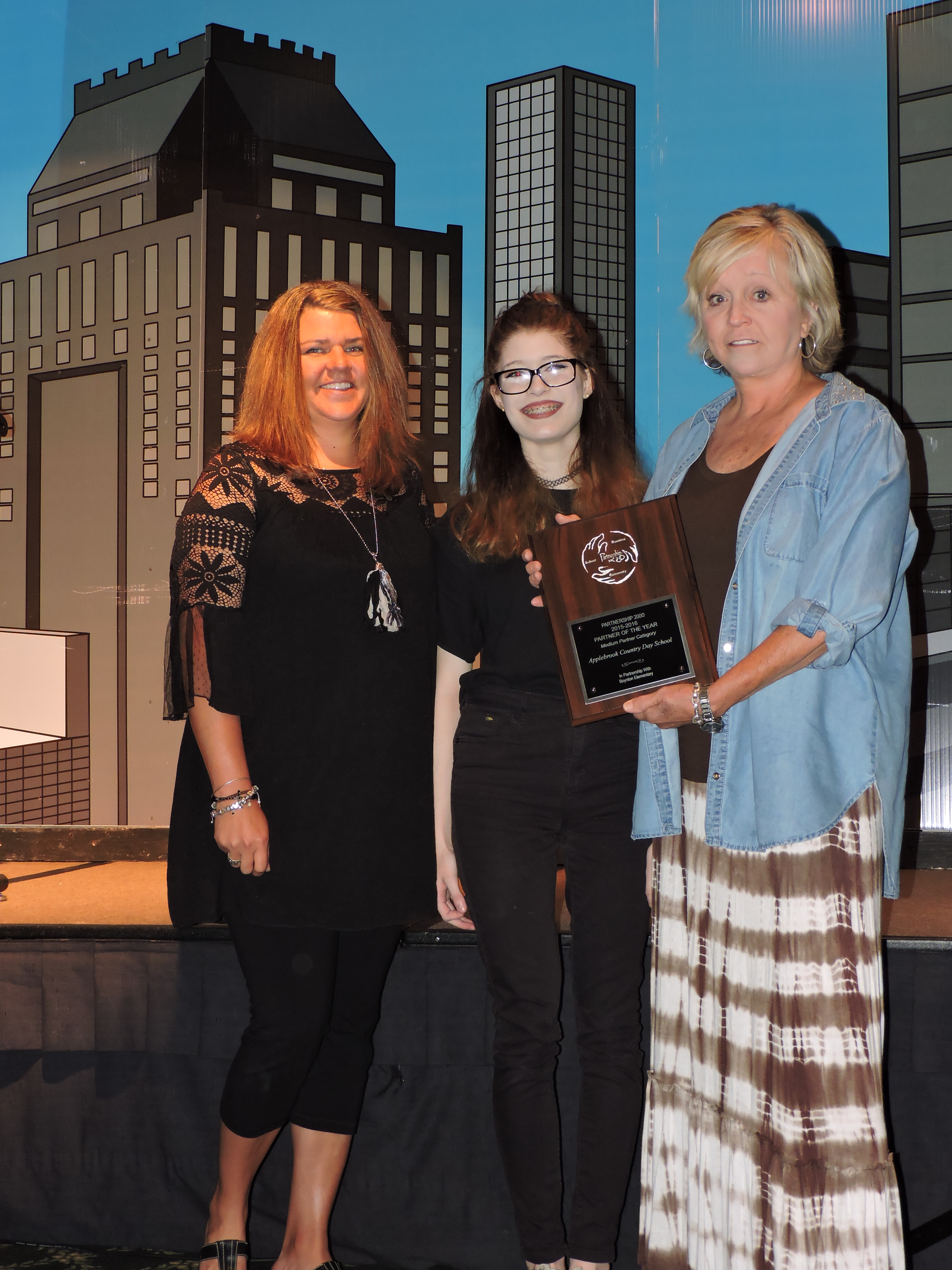 Representatives from Applebrook Country Day School accept the Medium Partner of the Year award from Lakeview-Fort Oglethorpe High School student Tessa Sentell, center. They have demonstrated their dedication through participation in the Barnacle Bay Playground Project, Grants for Growth and Meeting Needs at Home and Abroad, Best Foot Forward and more. Every year, the school helps provide supplies, technology and resources for students and teachers. Around the holidays, representatives deliver 31 families boxes of food and household items.