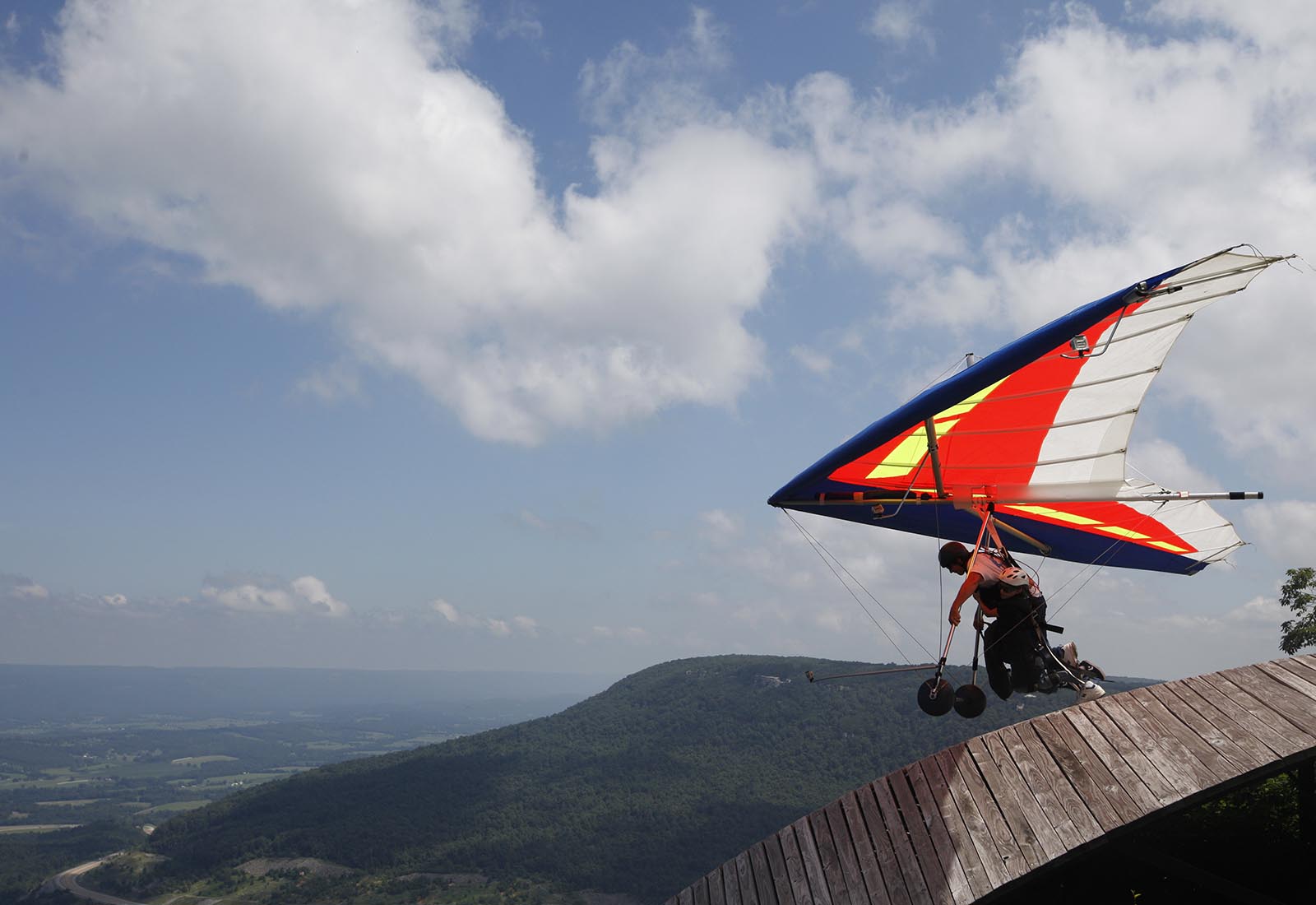 Staff Photo by Doug Strickland/Chattanooga Times Free Press - July 25, 2013. Clark Harlow, who runs Thrill-A-Minute Sports, a tandem hang-gliding service, launches a flight from the Tennessee Tree Toppers association's Henson's Gap launching ramp Thursday in Dunlap, Tenn.