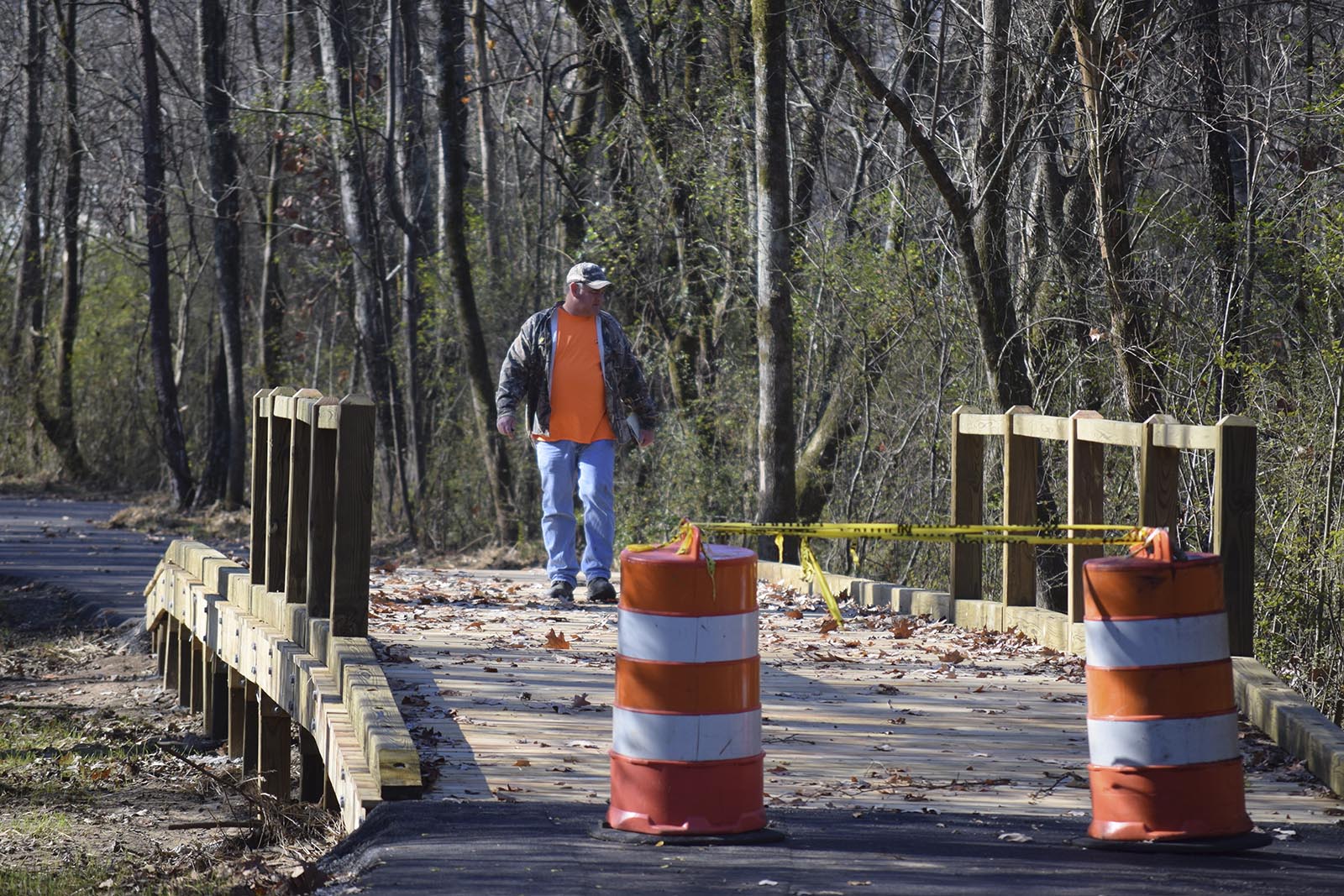 Tennessee Department of Transportation inspector Riley Henson walks over a boardwalk that is under construction. Crews are nearly finished with a segment along Coops Creek in Dunlap that completes the first three phases of the town's greenway project.
