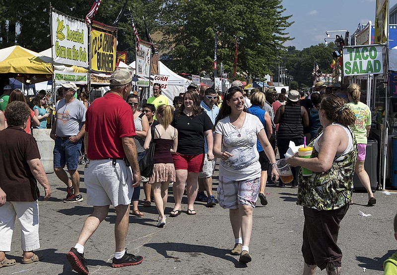 People gather at the Tennessee Strawberry Festival on Saturday, May 9, 2015, in Dayton, Tenn. The annual festival, held in historic downtown Dayton around the Rhea County Courthouse, brought crowds to browse the wares of craft vendors and food trucks.