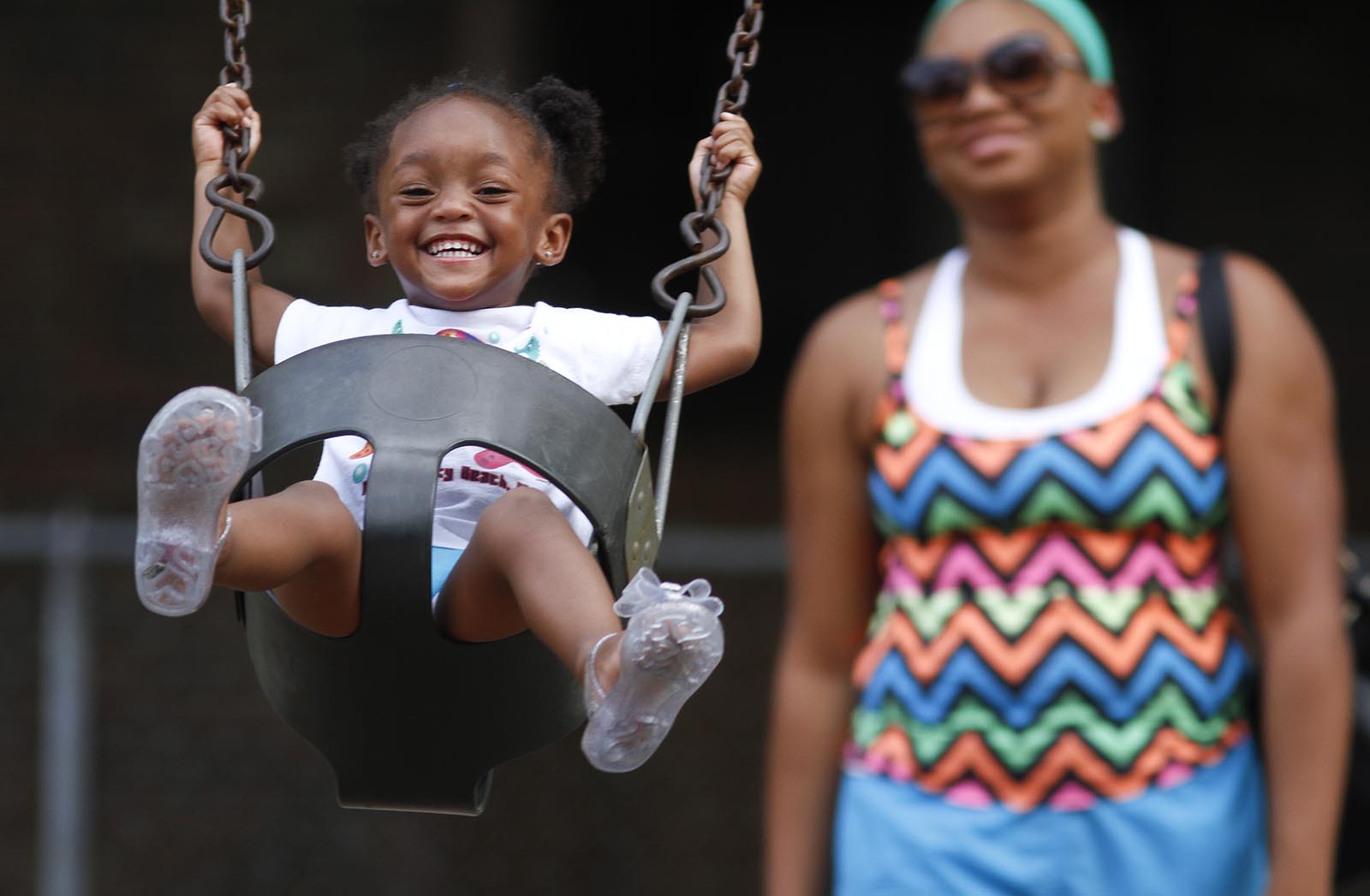 Staff Photo by Dan Henry / The Chattanooga Times Free Press- 7/14/14. Janelle Jenkins pushes her two-year-old daughter Gabrielle Harris on the swing while at Gilbert-Stephenson City Park in Fort Oglethorpe, Ga., on July 14, 2014.