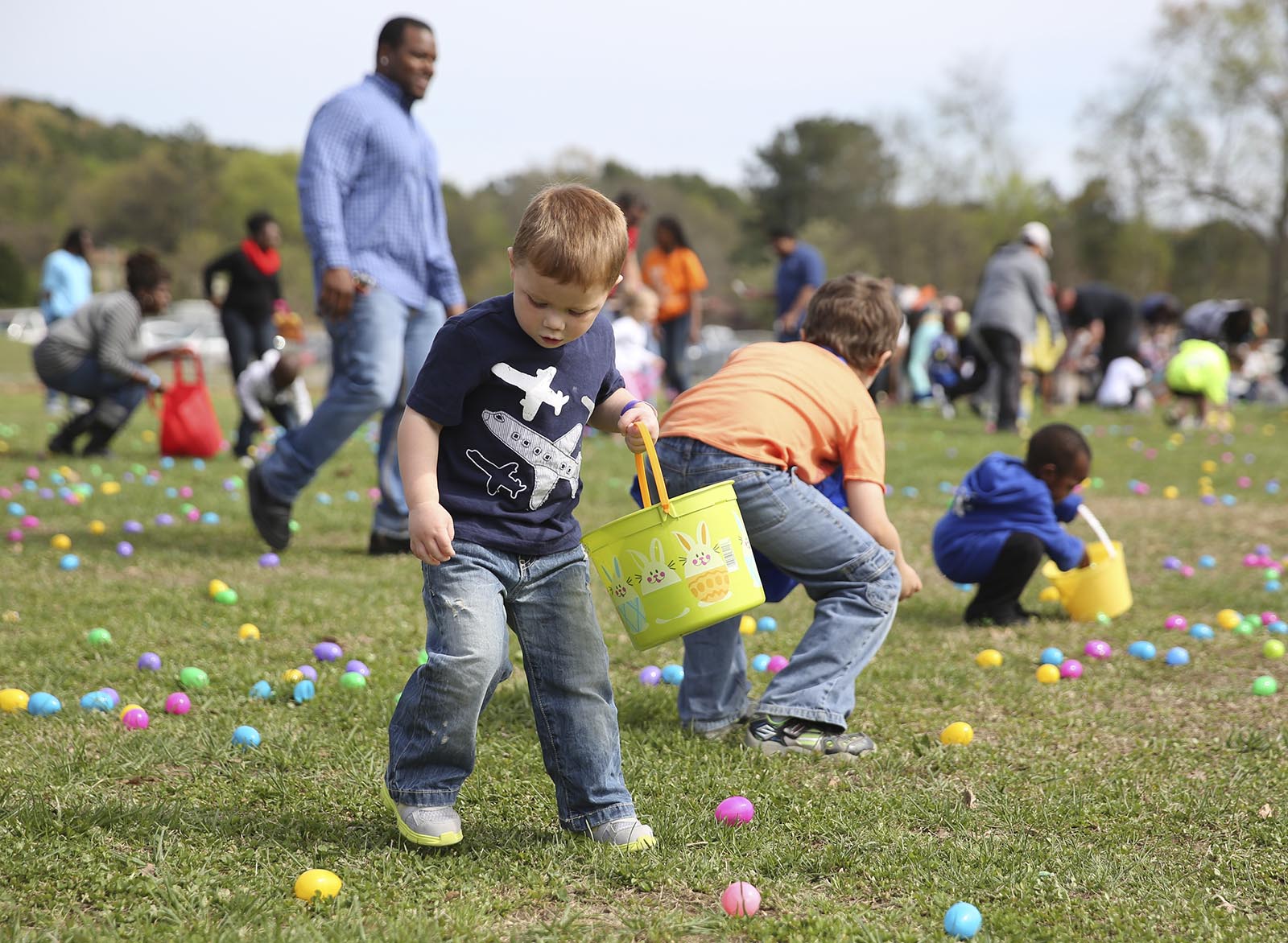 Ben Collett, 3, eyes an egg to pick up during the Easter egg hunt at Camp Jordan Park in East Ridge, Tenn., on Saturday, April 5, 2014. The event was put on by Venue Church.