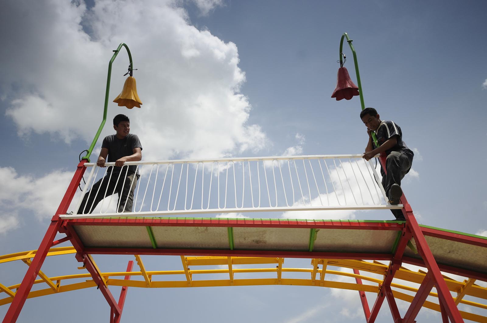 Workers assemble the "Wacky Worm" roller coaster Tuesday in the parking lot at Camp Jordan in preparation for The East Ridge State Fair. There will be 20-rides and 20-shows, according to Kim Gann at Camp Jordan. "They are assembling the rides and shows to circle the Camp Jordan Arena," Stump Martin said Tuesday afternoon. "Concessions will be inside and out at the arena." The event begins Thursday, June 25, and end Sunday, June 28, 2015.
