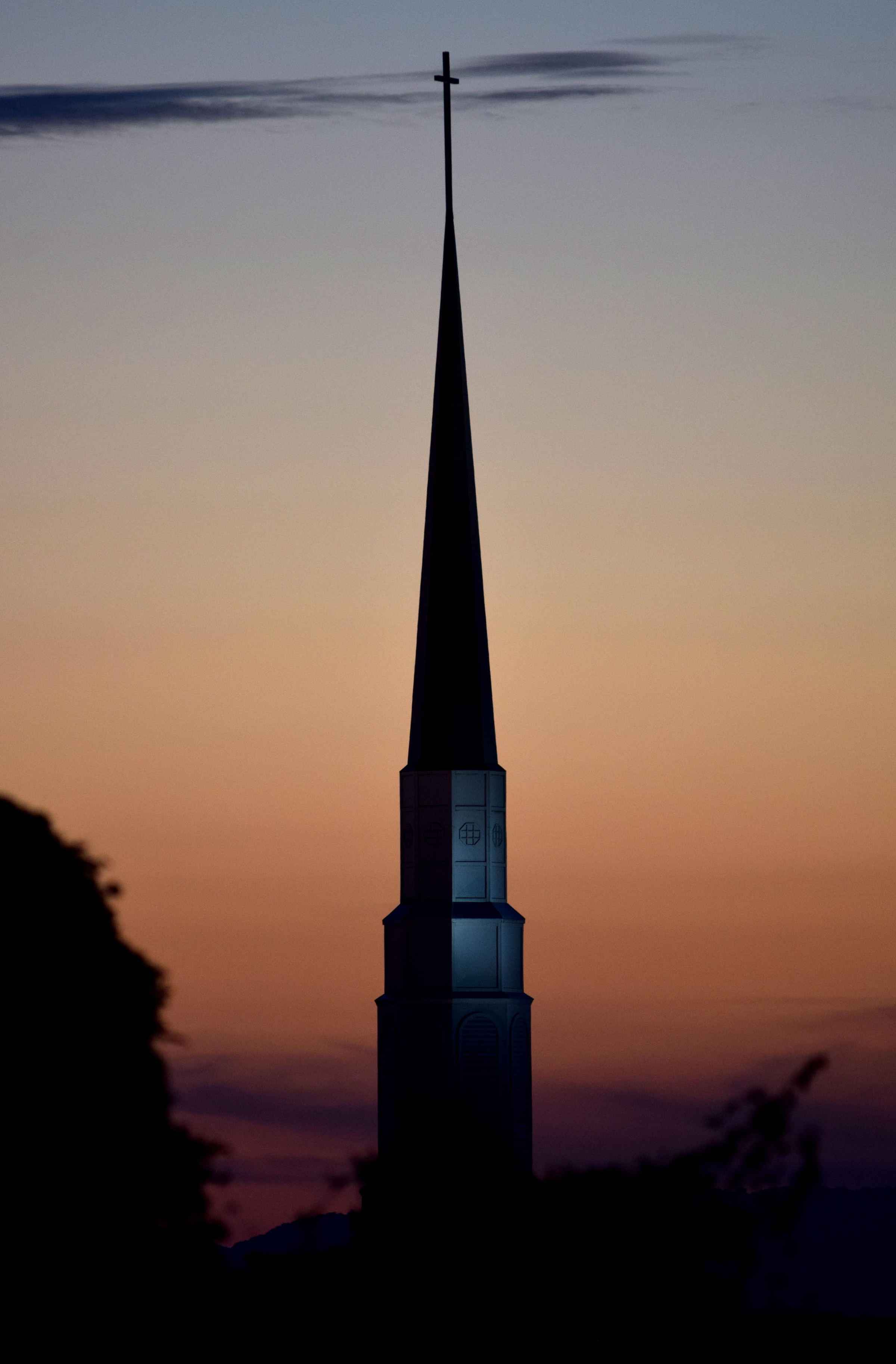 The massive steeple of Woodland Park Baptist Church is illuminated agasint a darkening western sky after sunset recently in the Tyner area of Chattanooga.