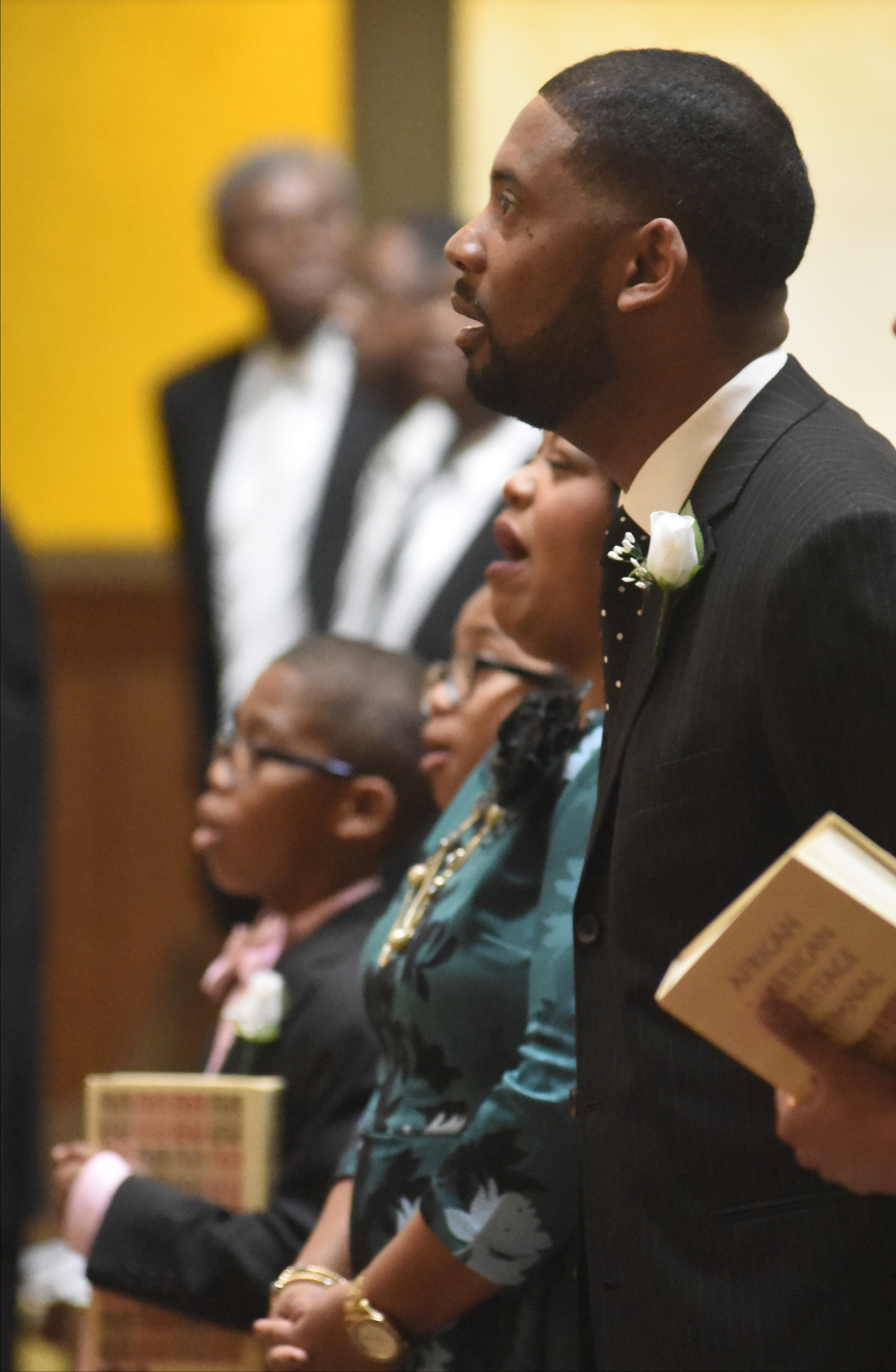 Rev. Dr. Ernest L. Reid, Jr., stands with his family and sings a hymn during a service where he was welcomed as the new pastor of the Second Missionary Baptist Church on Sunday, Oct. 18, 2015, in Chattanooga, Tenn. The church recently celebrated 149 years in operation and he is the 21st pastor in the church's history.