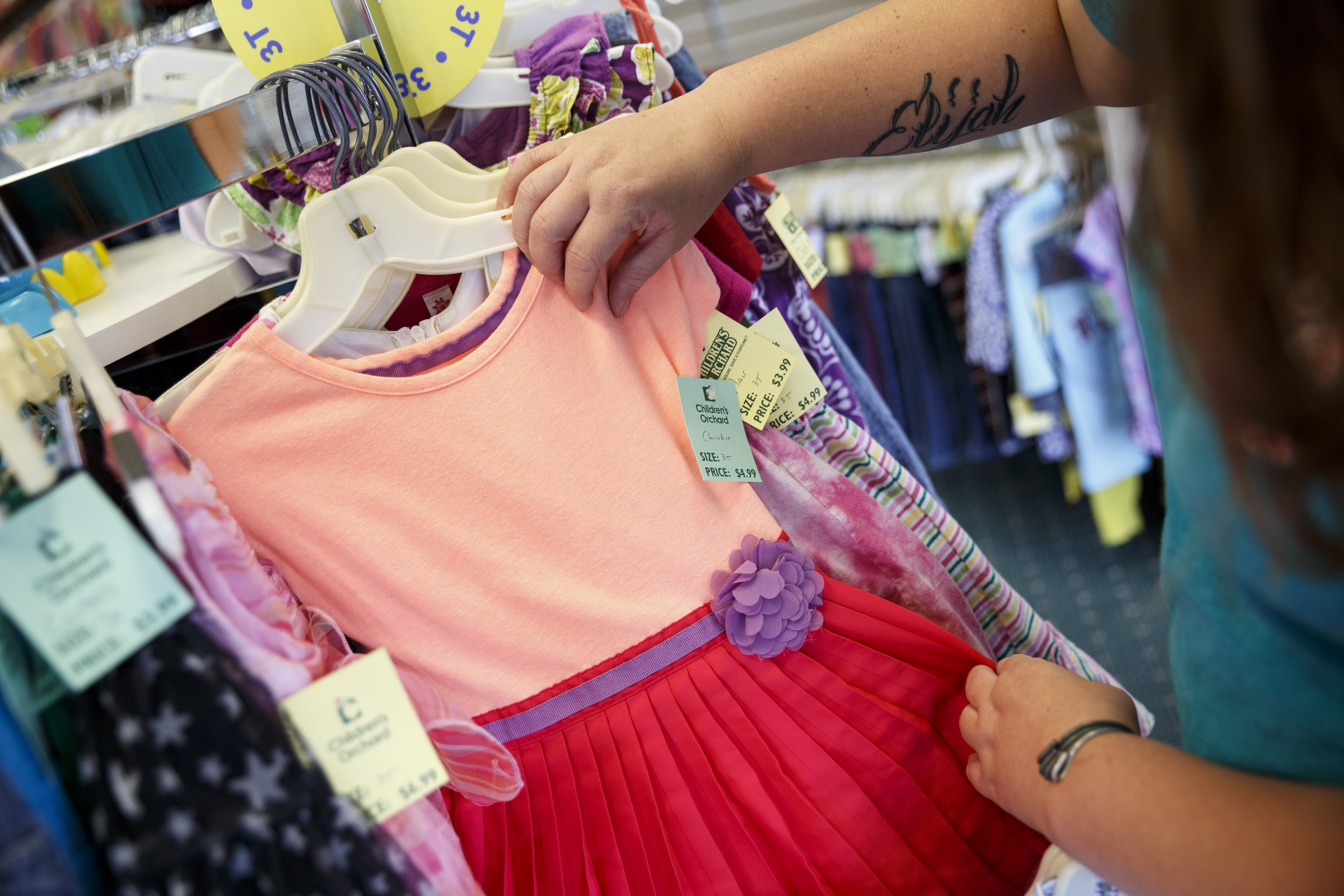 Ashley Lawson looks for clothes at Children's Orchard in Cleveland, Tenn. The store sells used children's clothes, toys and accessories brought in by customers, who can swap them for credit or cash.