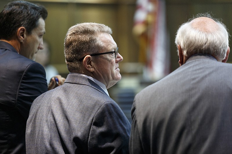 Defendant Billy Hawk, center, stands with defense attorneys Bill Speek, left, and Jim Logan during Hawk's murder trial in Judge Don Poole's courtroom in Hamilton County Criminal Court on Wednesday, June 1, 2016, in Chattanooga, Tenn. A grand jury indicted Hawk, 62, in September for first-degree murder in the 1981 slaying of Johnny Mack Salyer.