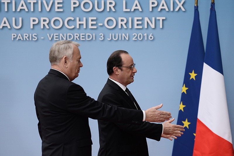 
              French President Francois Hollande and his Foreign Affairs minister Jean Marc Ayrault, left, arrive to attend an international meeting in a bid to revive the Israeli-Palestinian peace process in Paris, France, Friday, June 2, 2016. U.S., European and Arab diplomats meet in Paris for a French-led effort to revive the Mideast peace process, despite skepticism from Israel. (Stephane de Sakutin/Pool Photo via AP)
            