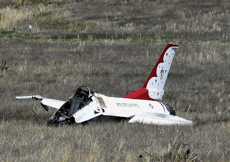 A U.S. Air Force Thunderbird that crashed following a flyover rests on the ground south of the Colorado Springs, Colo., airport after a performance at a commencement for Air Force Academy cadets Thursday, June 2, 2016. The pilot ejected safely from the jet. (Jerilee Bennett/The Gazette via AP)