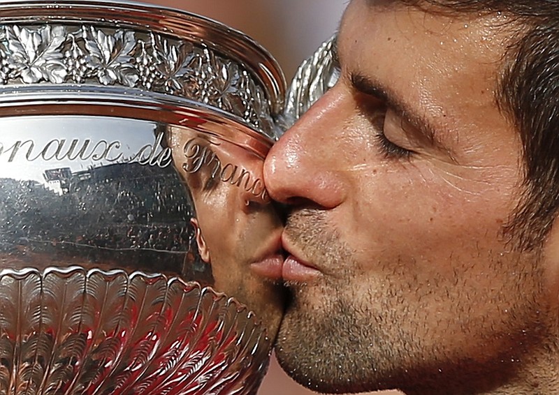 Serbia's Novak Djokovic kisses the La Coupe des Mousquetaires after beating Andy Murray on Sunday to win the French Open. It's his 12th major victory, five short of the record 17 won by Roger Federer.