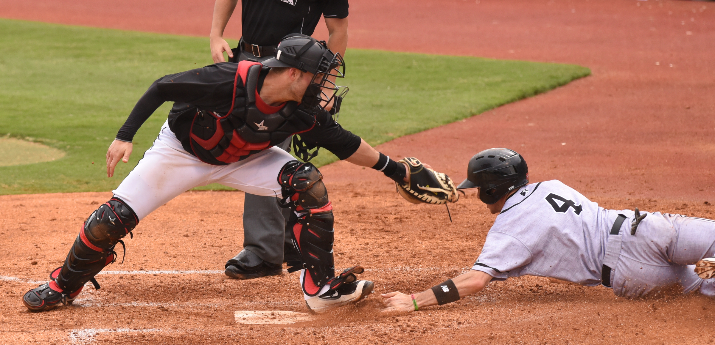 Chattanooga Lookouts catcher Mitch Garver reaches to make the tag as the Jacksonville Suns' J. T. Riddle slides safely across the plate Sunday, June 5, 2016 at AT&T Field.