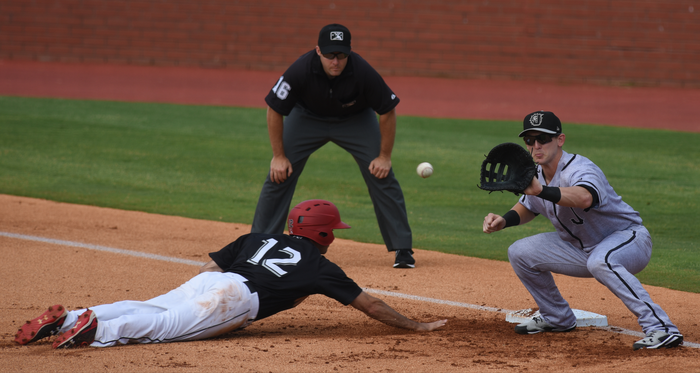 The Chattanooga Lookouts' Zack Granite dives safely back to base as Jacksonville Suns first baseman Chris Curley waits for the ball Sunday, June 5, 2016 at AT&T Field.