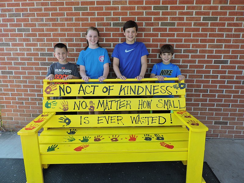 Chickamauga Elementary School and Gordon Lee Middle School students check out a new Buddy Bench donated to CES. From left are rising fourth-grader James Eldridge, rising eighth-grader Emilie Eldridge, rising eighth-grader Anthony Sikes and rising fifth-grader Luke Sikes.