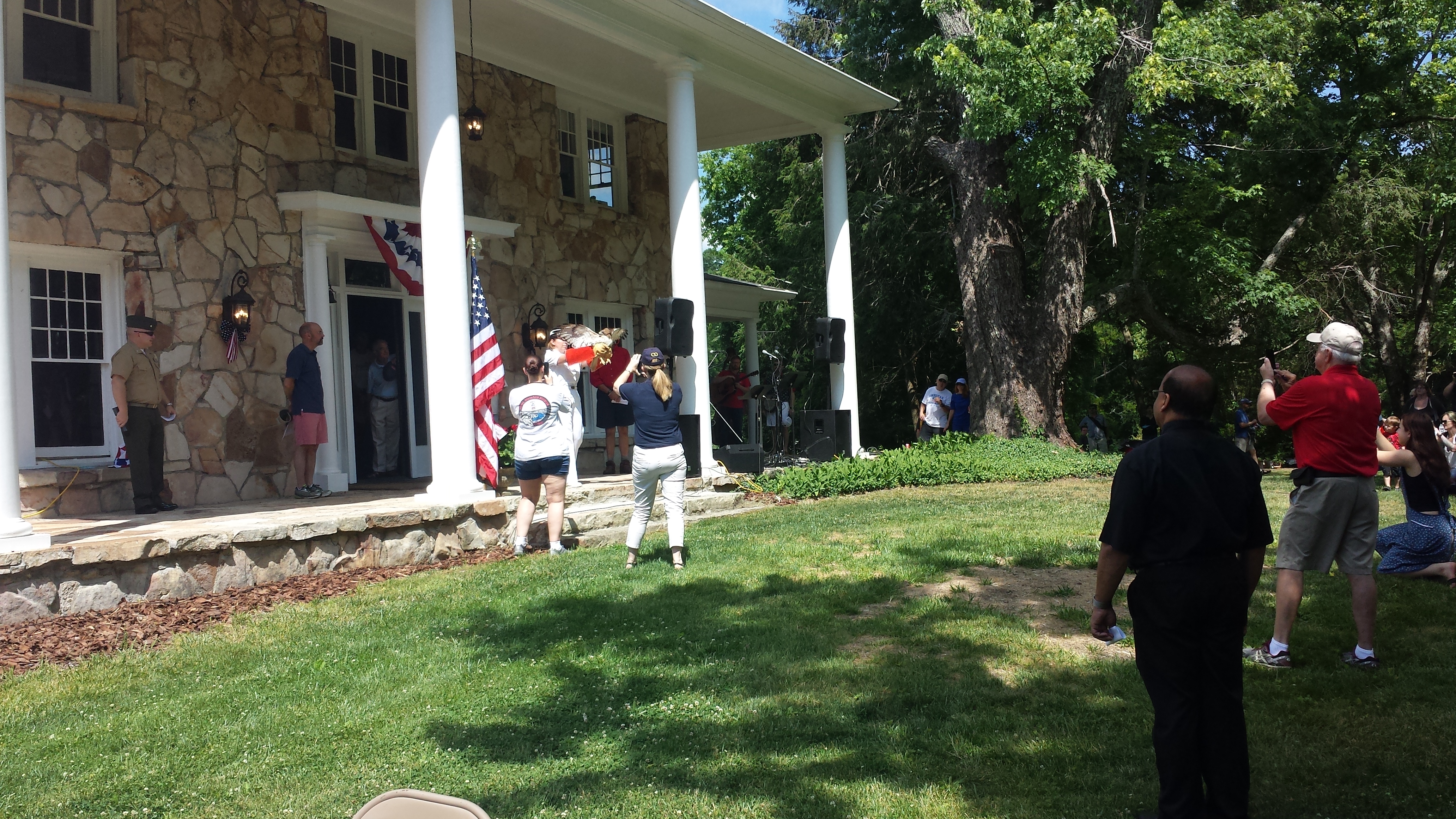 Attendees gather around the former home of Martha McCoy at the Memorial Day event held at McCoy Farms.