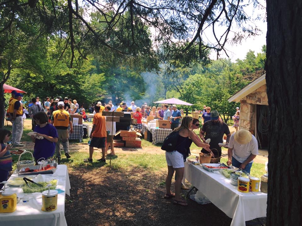 Picnic attendees fill their plates.