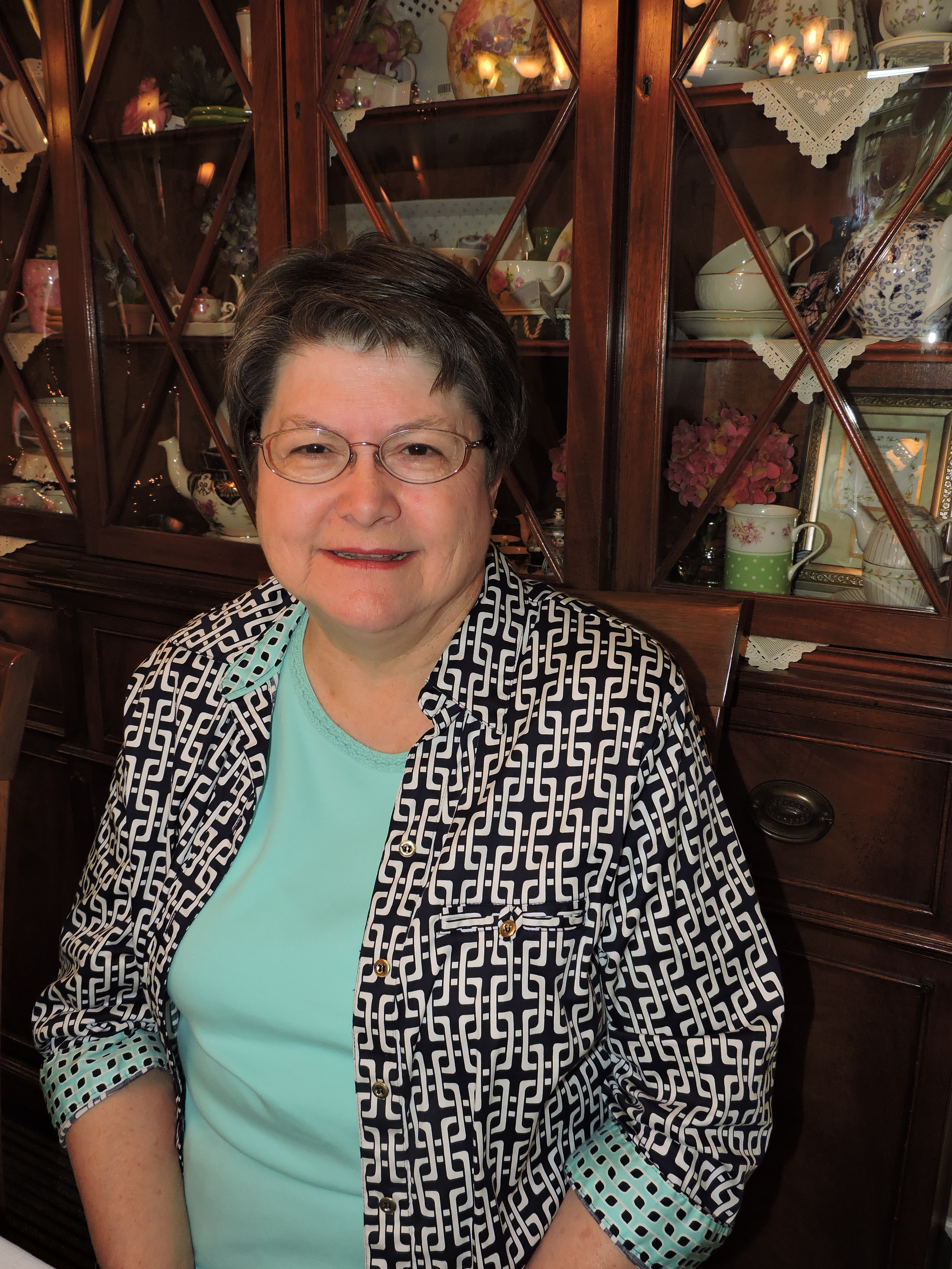 Cottage Treasures Tea Room manager Bettye Ziegler sits in the dining room at the restaurant. Each room in the tea room has a Bible verse on the wall from Matthew 19:26 that reads: "With God, all things are possible."