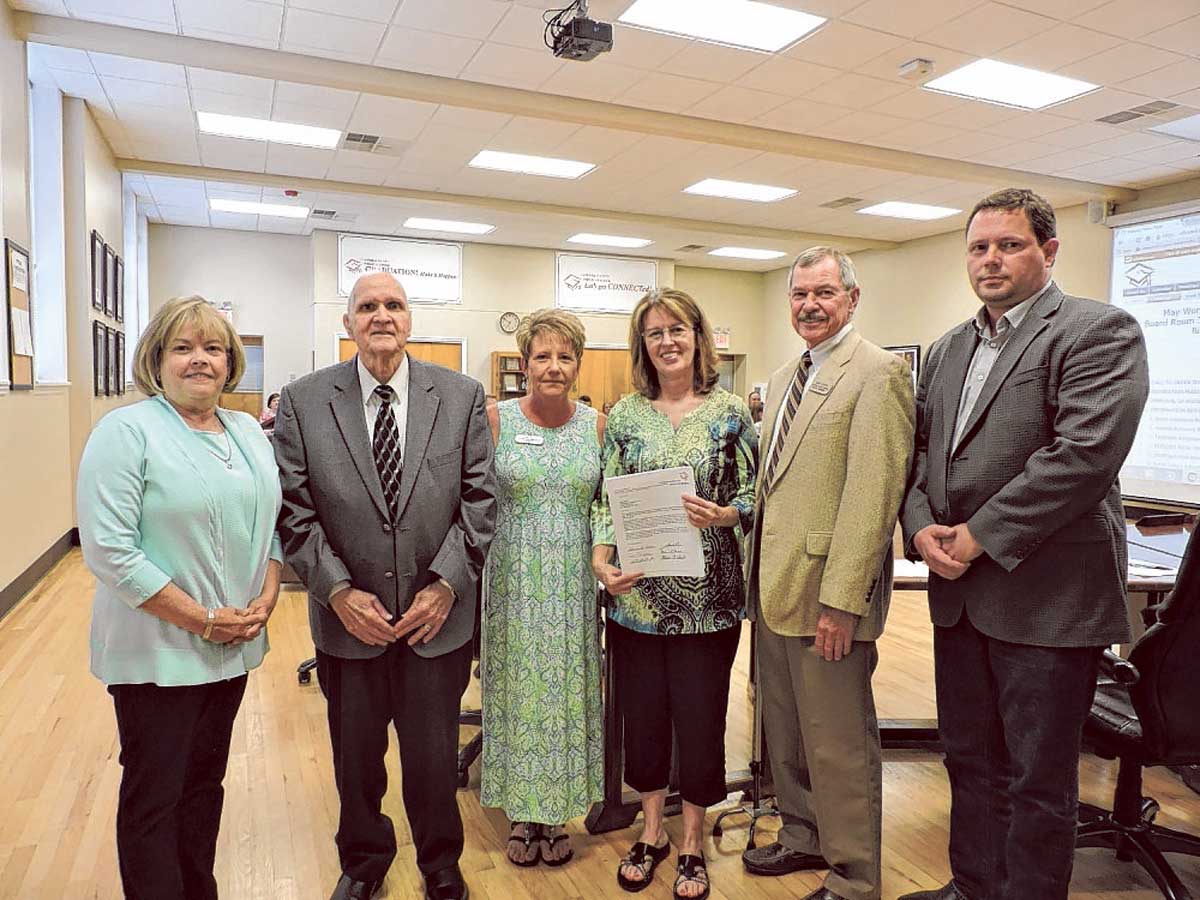Gail Helton, fourth from left, is named the Support Personnel Shining Star. From left, Catoosa County Board of Education members Gloria Hunt, Melvin Edwards, Superintendent Denia Reese, Chairman Don Dycus and David Moeller take part in the awards presentation.