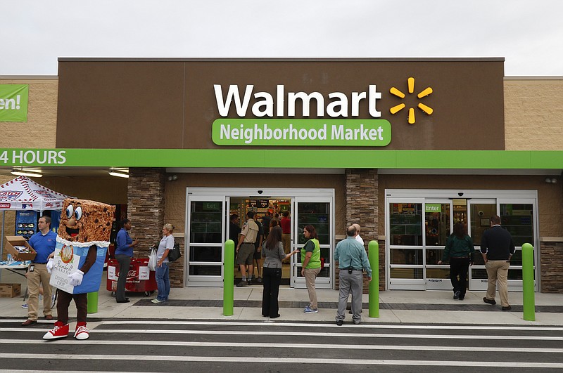 Staff file photo / Patrons enter the new building during the grand opening of the Walmart Neighborhood Market off of East Brainerd Road in Chattanooga, Tennessee, on September 9, 2015. 