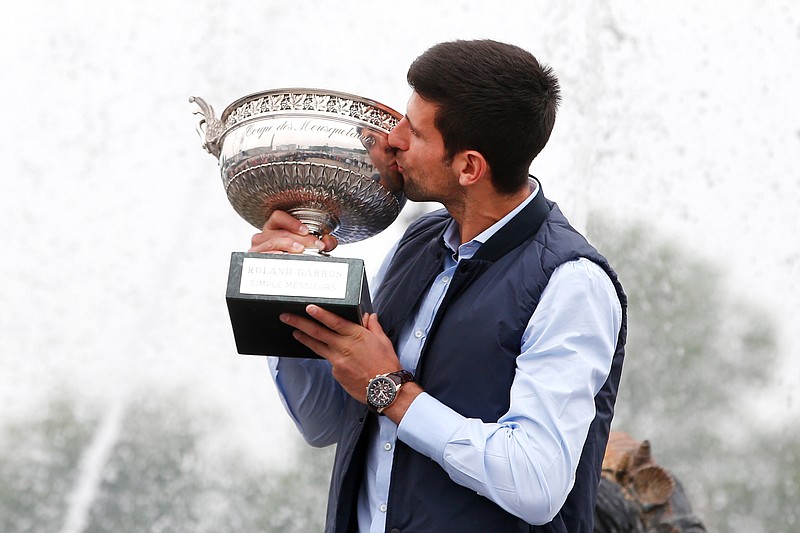 
              Novak Djokovic, from Serbia, kisses the French Open tennis trophy during a photo session at the Place de la Concorde, in Paris, Monday June 6, 2016. Djokovic was the winner against Britain's Andy Murray in four sets 3-6, 6-1, 6-2, 6-4. (AP Photo/Thibault Camus)
            