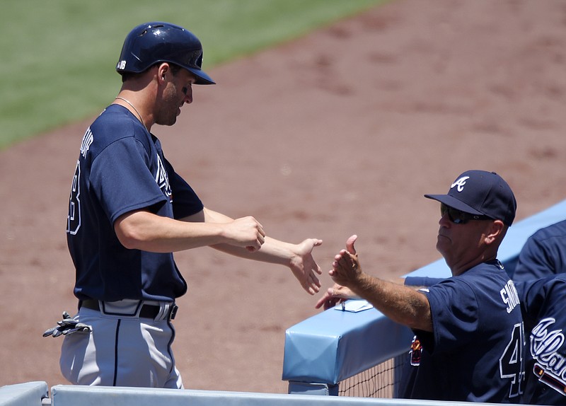 Atlanta Braves' Jeff Francoeur, left, is congratulated by interim manager Brian Snitker after scoring on a single by Nick Markakis during the first inning of a baseball game against the Los Angeles Dodgers, Sunday, June 5, 2016, in Los Angeles, Calif. (AP Photo/Mark J. Terrill)