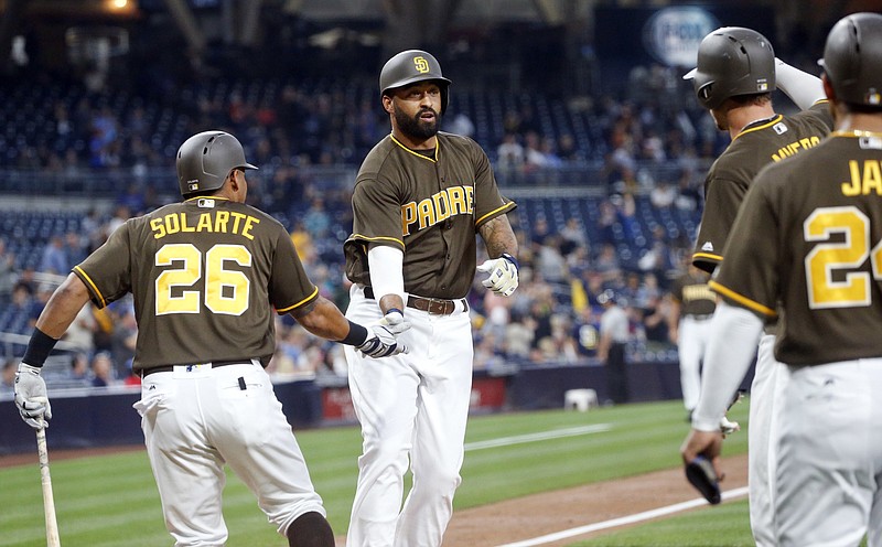 San Diego Padres' Matt Kemp is congratulated by Yangervis Solarte after blasting a three run homer against the Colorado Rockies during the first inning of a baseball game Friday, June 3, 2016, in San Diego.