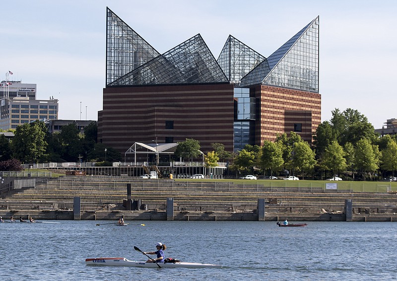 Myrlene Marsa paddles her SurfSki in the Tennessee River past the Tennessee Aquarium on Wednesday, May 13, 2015, in Chattanooga.
