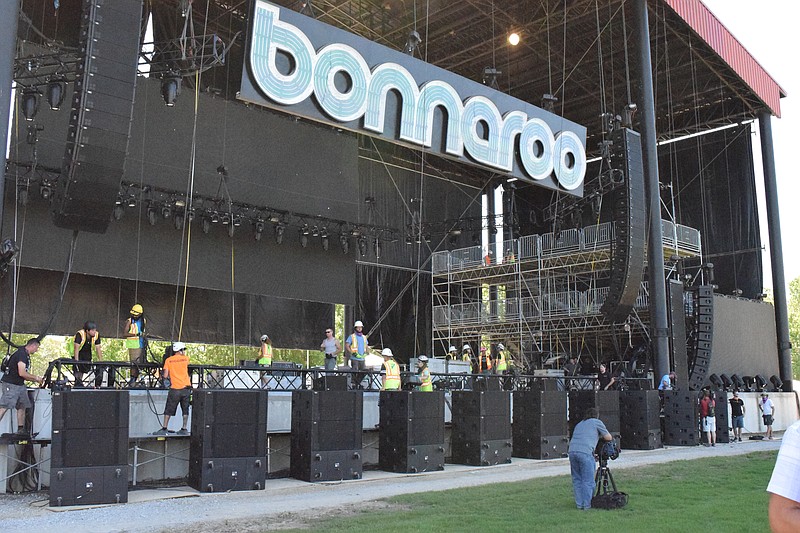 Crew members work to get the What Stage ready for this year's Bonnaroo Music and Arts Festival in Manchester, Tenn.