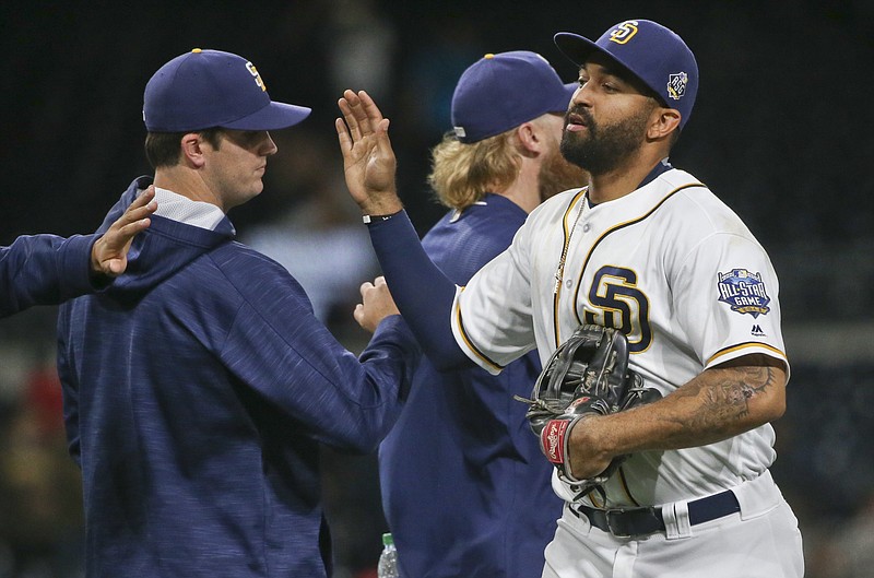 San Diego Padres' Matt Kemp, who had two hits and drove in two runs, high fives his way through teammates after the Padres 7-2 victory over the Atlanta Braves in a baseball game Monday, June 6, 2016, in San Diego. 