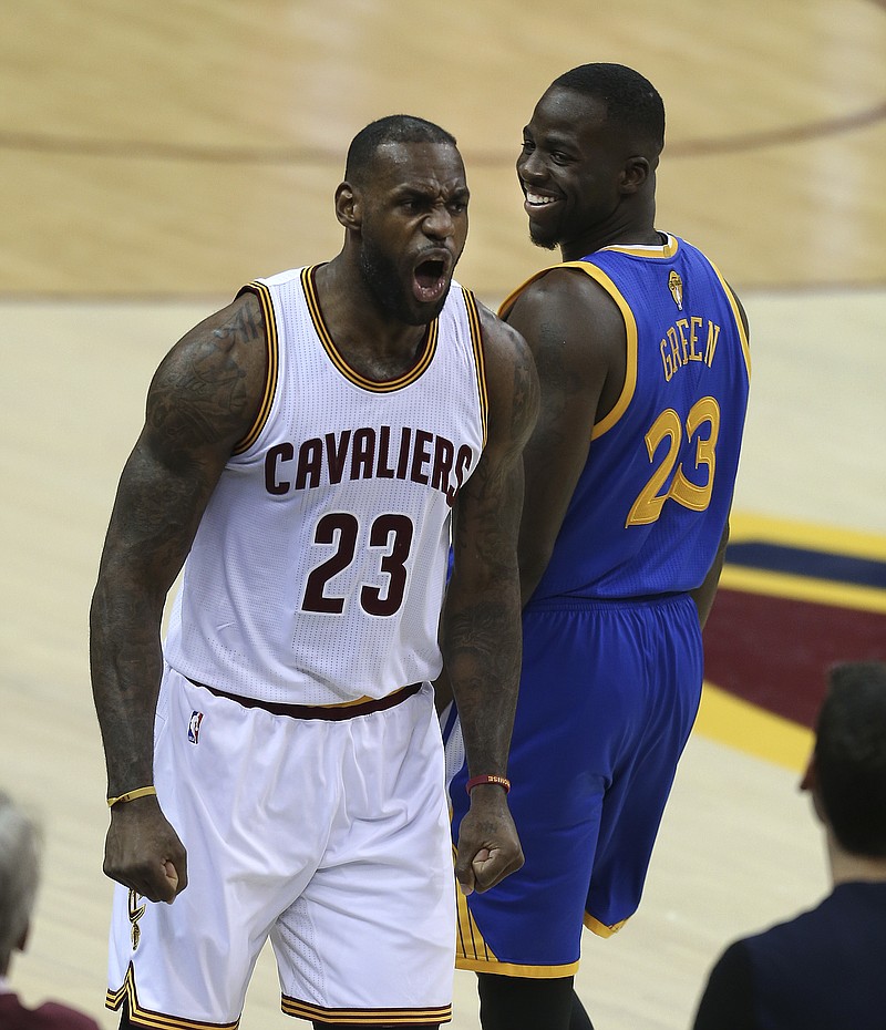 
              Cleveland Cavaliers forward LeBron James, left, reacts as Golden State Warriors forward Draymond Green, right, looks back during the first half of Game 3 of basketball's NBA Finals in Cleveland, Wednesday, June 8, 2016. (AP Photo/Ron Schwane)
            