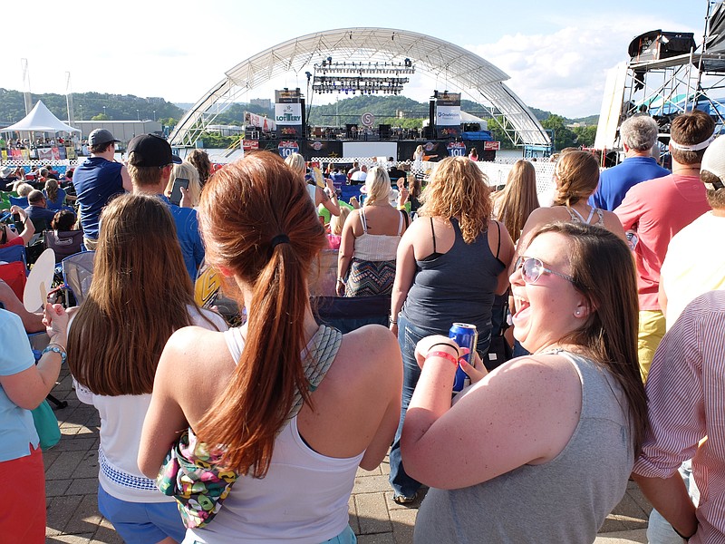 Briditte Debien, right, of Cookeville, and Katherine Mercer, of Nashville, sing along during a Cole Swindell show.