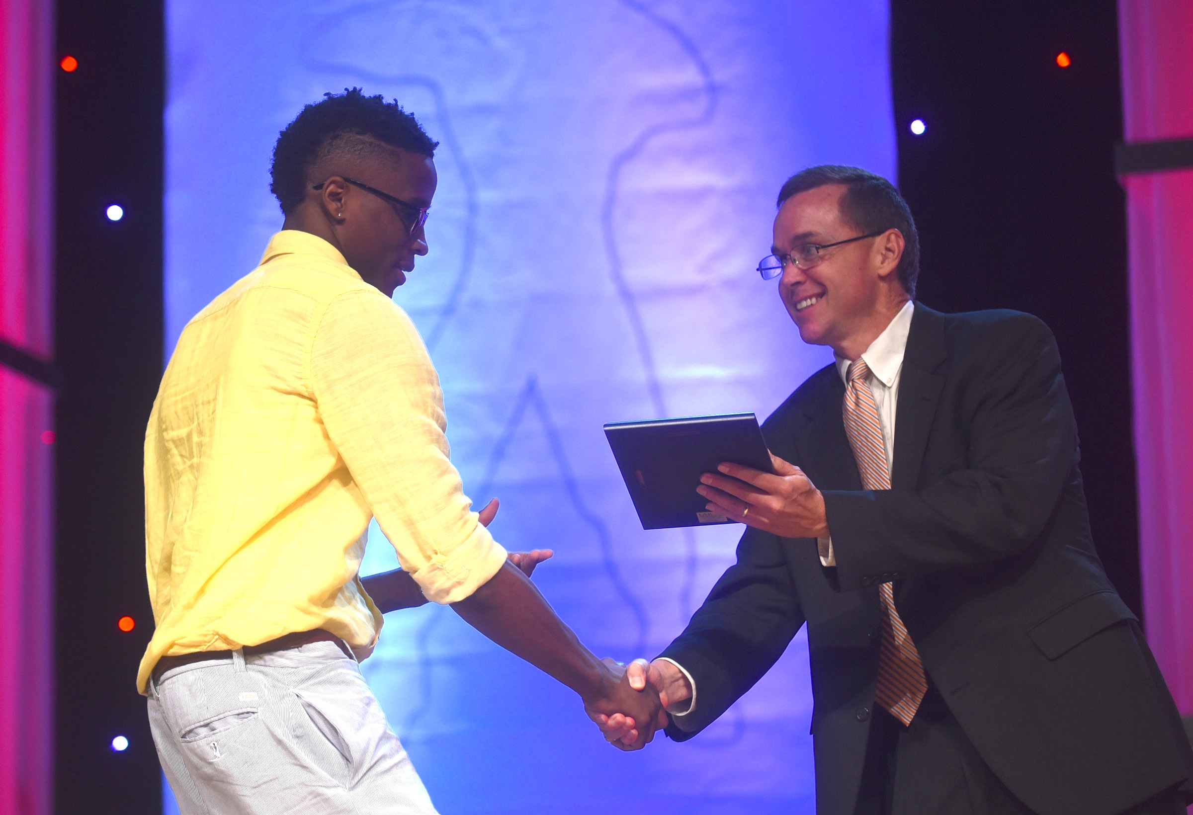Brainerd's Dajuonta Ross accepts the Robert High award for outstanding achievement in boys basketball from David Paschall at the Best of Preps banquet Thursday, June 9, 2016 at the Chattanooga Convention Center.
