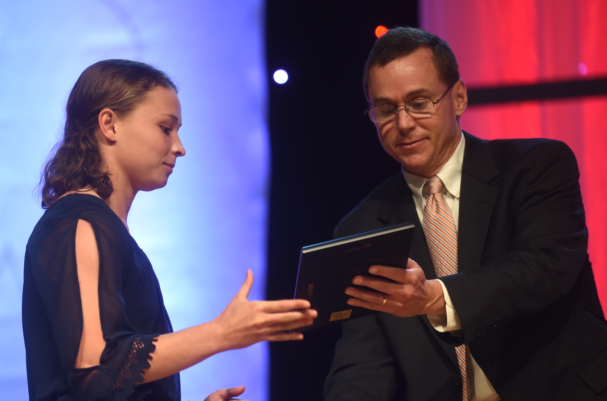 McKenzie Ethridge accepts the Laquisha Jackson award for outstanding achievement in girl's track from David Paschall at the Best of Preps banquet Thursday, June 9, 2016 at the Chattanooga Convention Center. Ethridge was also named the Scrappy Moore female athlete of the year.