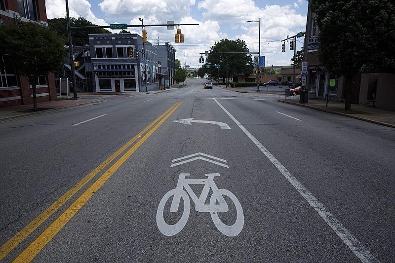 An existing bike lane marker in a turn lane is visible on Frazier Avenue on Tuesday, June 7, 2016, in Chattanooga, Tenn. A transportation design firm has suggested the city temporarily stripe Frazier Avenue before going through with proposed bike lanes that would reduce the road to two lanes and a turn lane.