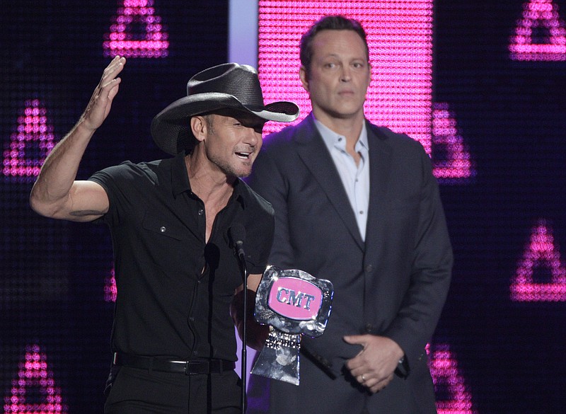 Tim McGraw accepts the award for video of the year for "Humble and Kind" at the CMT Music Awards at the Bridgestone Arena on Wednesday, June 8, 2016, in Nashville. Looking on at right is presenter Vince Vaughn. 