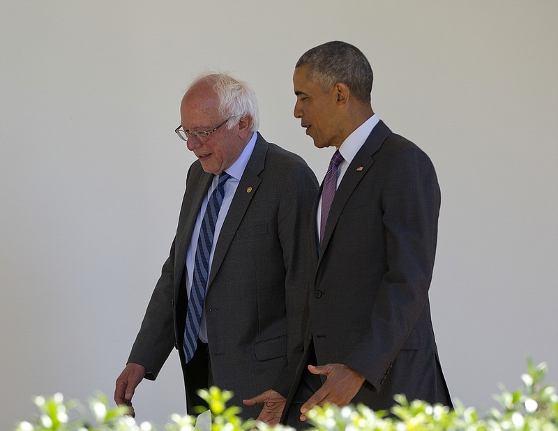 President Barack Obama walks with Democratic presidential candidate Sen. Bernie Sanders, I-Vt., down the Colonnade of the White House in Washington on Thursday, June 9, 2016. 