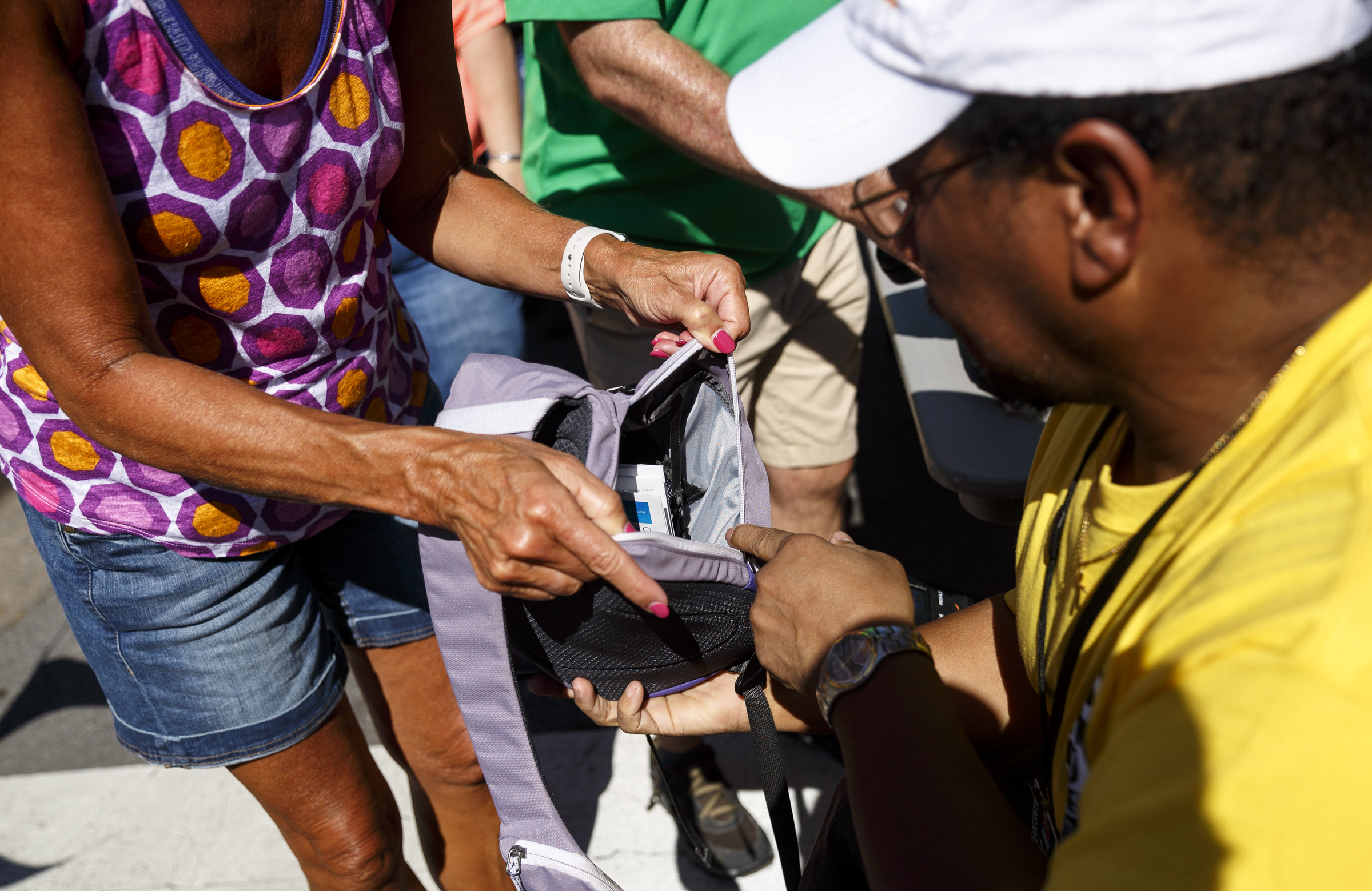 Tommy Gates checks the handbag of a woman as she enters the festival on the 1st day of the Riverbend Festival at Ross's Landing on Friday, June 10, 2016, in Chattanooga, Tenn. The festival is celebrating its 35th year, and Thomas Rhett was Friday night's headlining act.