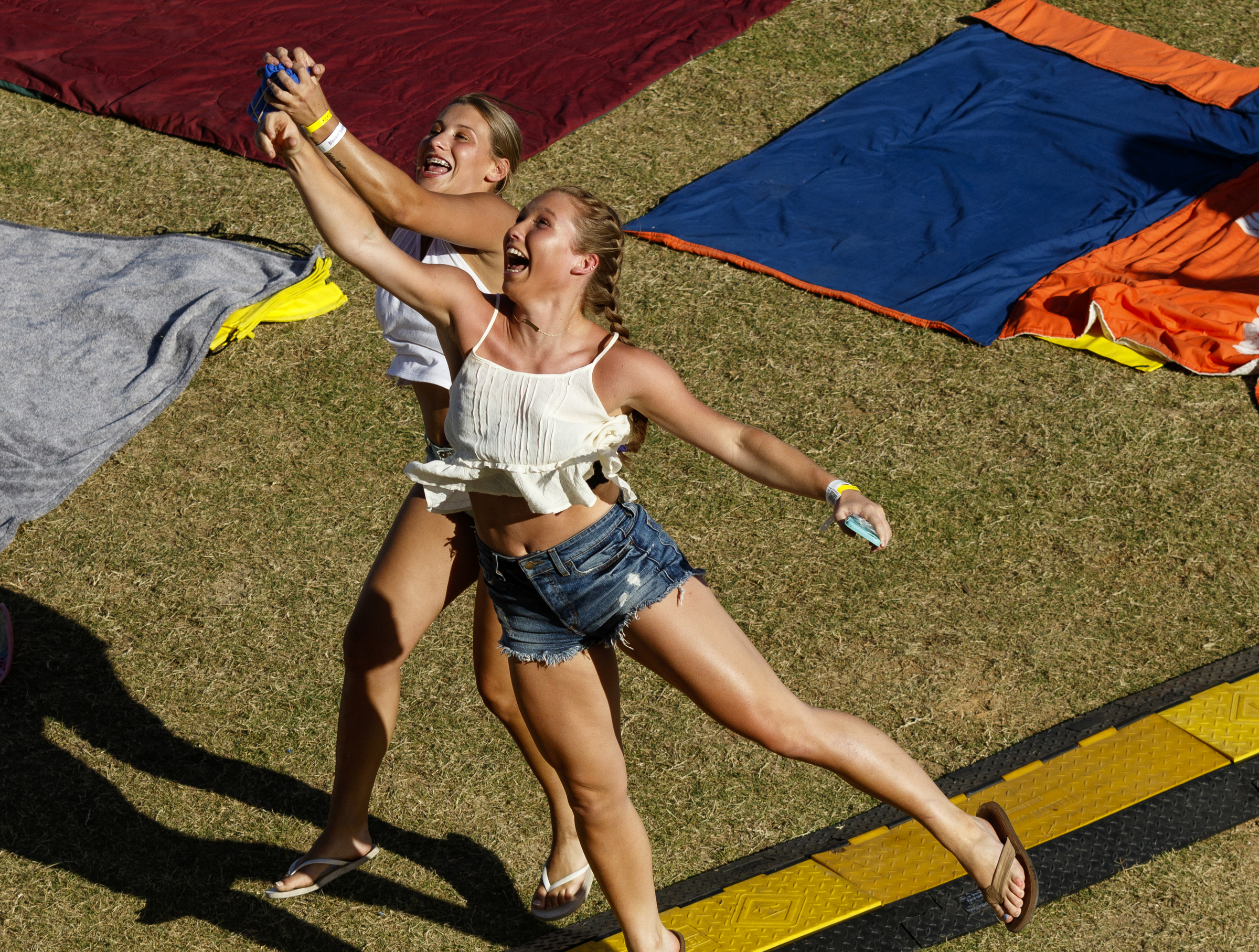 Two girls jump to catch a t-shirt launched from the Coca Cola stage on the 1st day of the Riverbend Festival at Ross's Landing on Friday, June 10, 2016, in Chattanooga, Tenn. The festival is celebrating its 35th year, and Thomas Rhett was Friday night's headlining act.