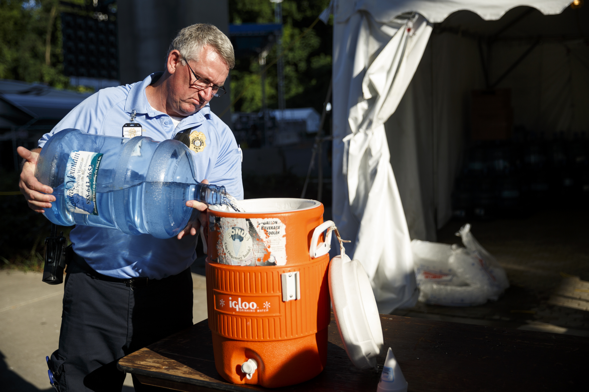 Hamilton County EMS worker James Dotson pours water into a cooler for the public on the 1st day of the Riverbend Festival at Ross's Landing on Friday, June 10, 2016, in Chattanooga, Tenn. The festival is celebrating its 35th year, and Thomas Rhett was Friday night's headlining act.