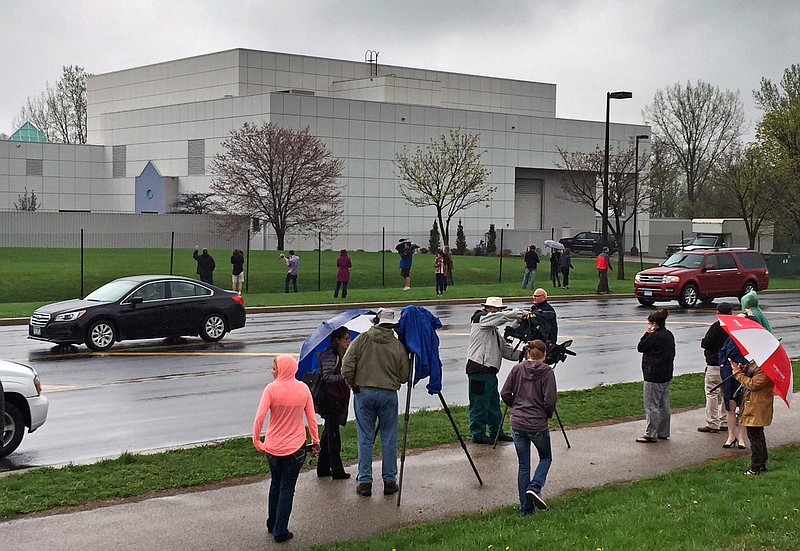 
              FILE - In this April 21, 2016 file photo, people stand outside entertainer Prince's Paisley Park compound in Chanhassen, Minn. Court filings in Prince's estate show that a special administrator, and likely Prince's siblings, are eager to explore the money-making potential of making a tourist attraction out of his Paisley Park home and studio complex.  (Jim Gehrz/Star Tribune via AP, File)  MANDATORY CREDIT; ST. PAUL PIONEER PRESS OUT; MAGS OUT; TWIN CITIES LOCAL TELEVISION OUT   TV is soft out
            