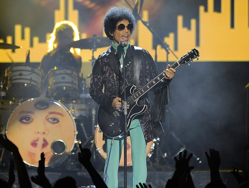 
              FILE - In this May 19, 2013, file photo, Prince performs at the Billboard Music Awards at the MGM Grand Garden Arena in Las Vegas.  It’s not clear if any doctor could have averted the fentanyl overdose that killed Prince in April 2016. But his death may offer evidence for how the special treatment often afforded the rich and famous can result in worse health care than ordinary Americans receive. (Photo by Chris Pizzello/Invision/AP, File)
            