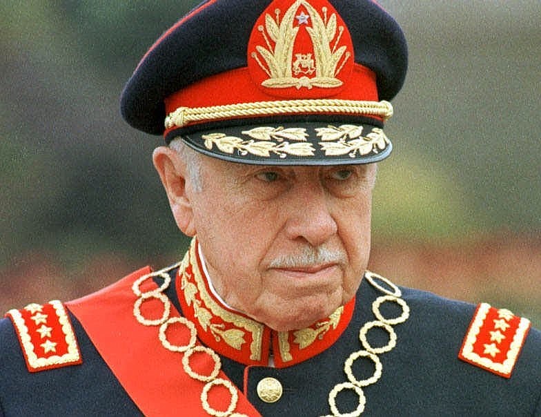 
              FILE - In this March 10, 1998 file photo, former Chilean dictator Gen. Augusto Pinochet is shown in Santiago, Chile. The ghosts of Chile's four-decade-old, bloody coup d'etat, which led to the torture, and disappearance of thousands of political opponents, are coming to an Orlando, Florida courtroom with the start of a civil trial involving a military commander and the family of Victor Jara. The family of Jara is suing Lt. Pedro Pablo Barrientos Nunez, a former military officer in the regime of Gen. Augusto Pinochet for damages, claiming that Barrientos Nunez was in charge of the stadium where Jara was tortured and killed in 1973. The trial starts in Orlando, Fla., Monday, June 13. 2016.(AP Photo/Santiago Llanquin, File)
            