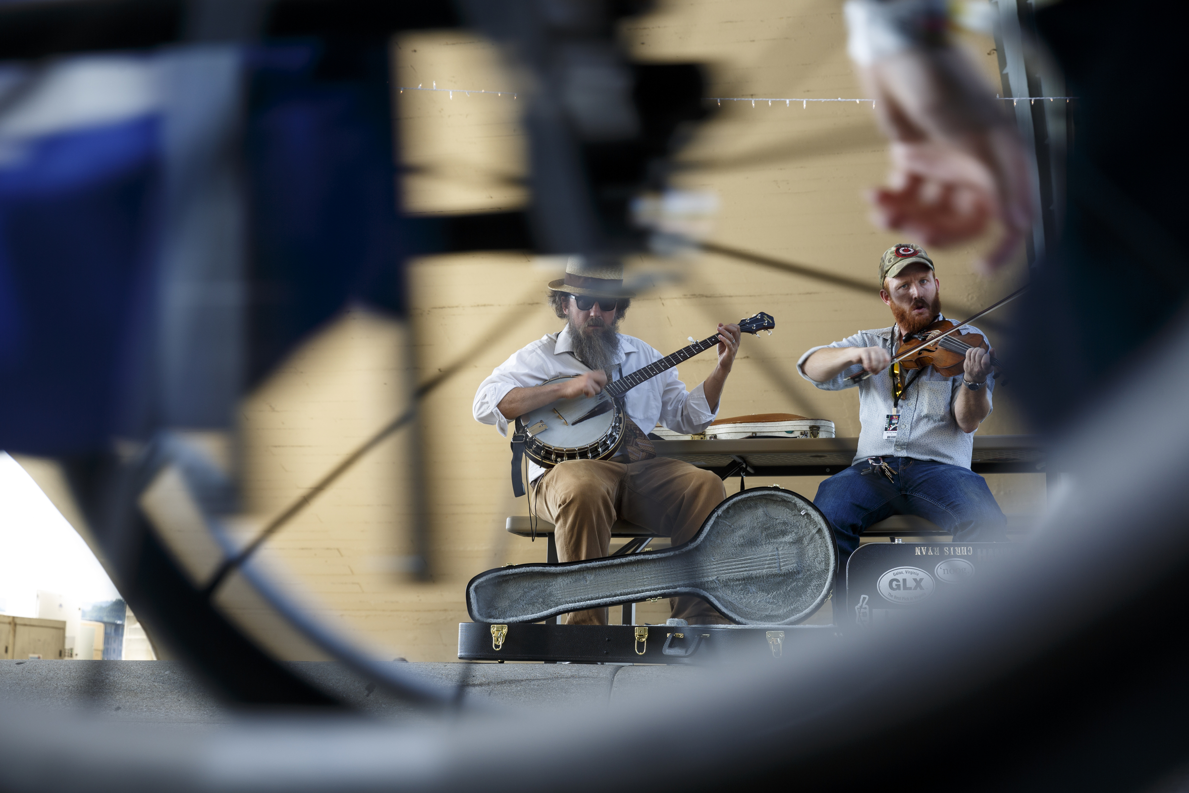 Matt Downer, left, and Chris Ryan with the Old Time Travelers as seen through the wheels of a passing wheelchair as they perform on Riverside Drive on the 2nd day of the Riverbend Festival at Ross's Landing on Saturday, June 11, 2016, in Chattanooga, Tenn. Rock band Heart headlined Saturday night.