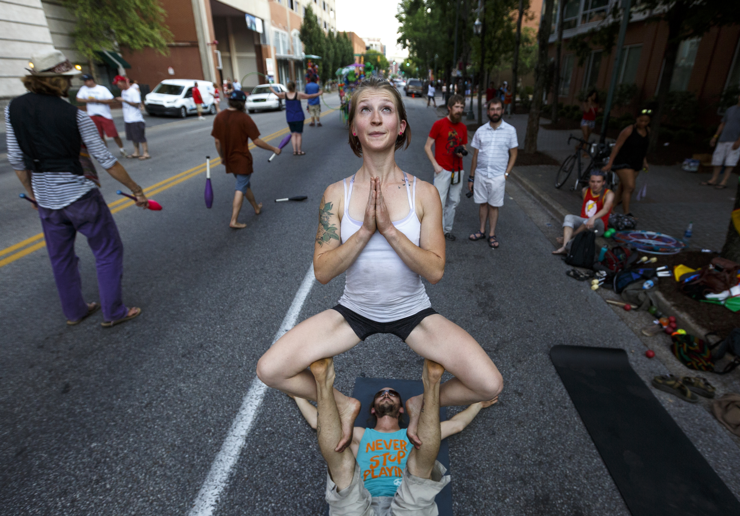 Brad Jenkins and Amanda Graves with Chattanooga Circus and Acro perform acro-yoga on the street outside the festival on the 2nd day of the Riverbend Festival at Ross's Landing on Saturday, June 11, 2016, in Chattanooga, Tenn. Rock band Heart headlined Saturday night.