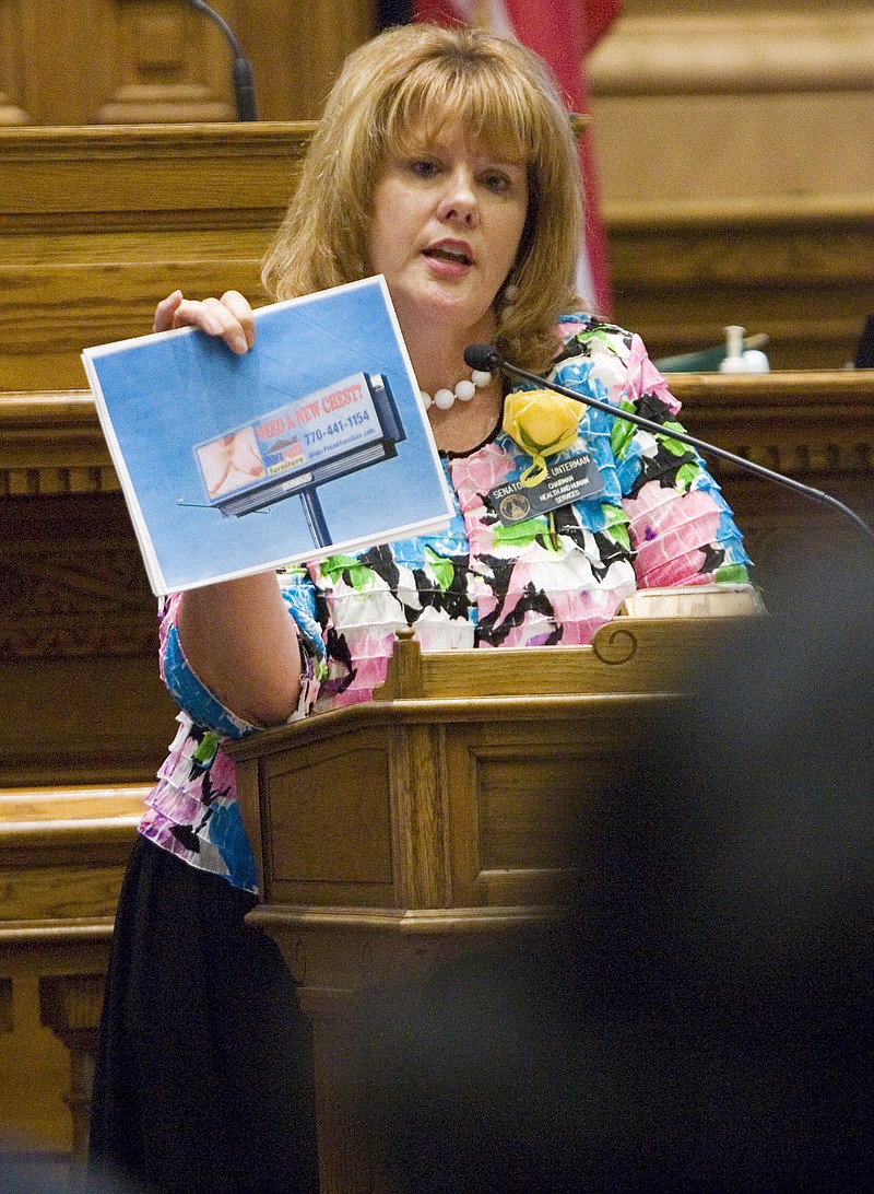 
              FILE - In this March 8, 2011 file photo, Sen. Renee Unterman, R-Buford, shows fellow senators an example of a billboard while addressing the senate chamber on a bill in Atlanta.  In 2014, Unterman helped lead an effort to shut down Medicaid expansion in Georgia.  Now the chair of the Senate health committee wants her colleagues to reconsider years of opposition to any form of Medicaid expansion.  (AP Photo/John Amis)
            