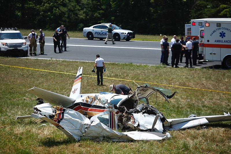 Investigators work the scene of a plane crash at Collegedale Municipal Airport on Saturday, June 11, 2016 in Collegedale, Tenn