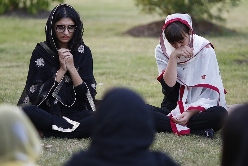 Staff Photo by Dan Henry / The Chattanooga Times Free Press- 6/12/16. Yusra Siddiqui, left, and Jenishea Lewis become emotional during a prayer vigil held with permission from the Islamic Society of Greater Chattanooga on Sunday, June 12, 2016. The vigil was in response to a mass shooting by an American-born man who pledged allegiance to ISIS killing 50 people early Sunday at a gay nightclub in Orlando, Florida. 